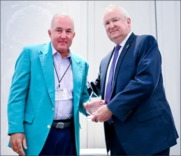 Two men at NCSC event holding award plaque