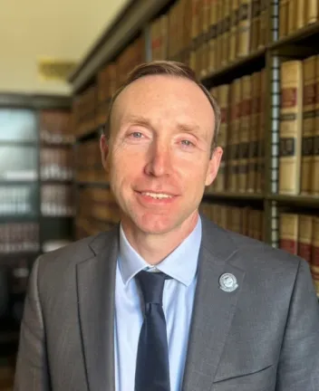 Professional man in suit and tie in legal library.