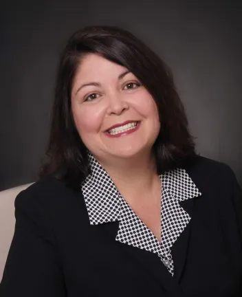 Professional portrait of woman with dark hair smiling